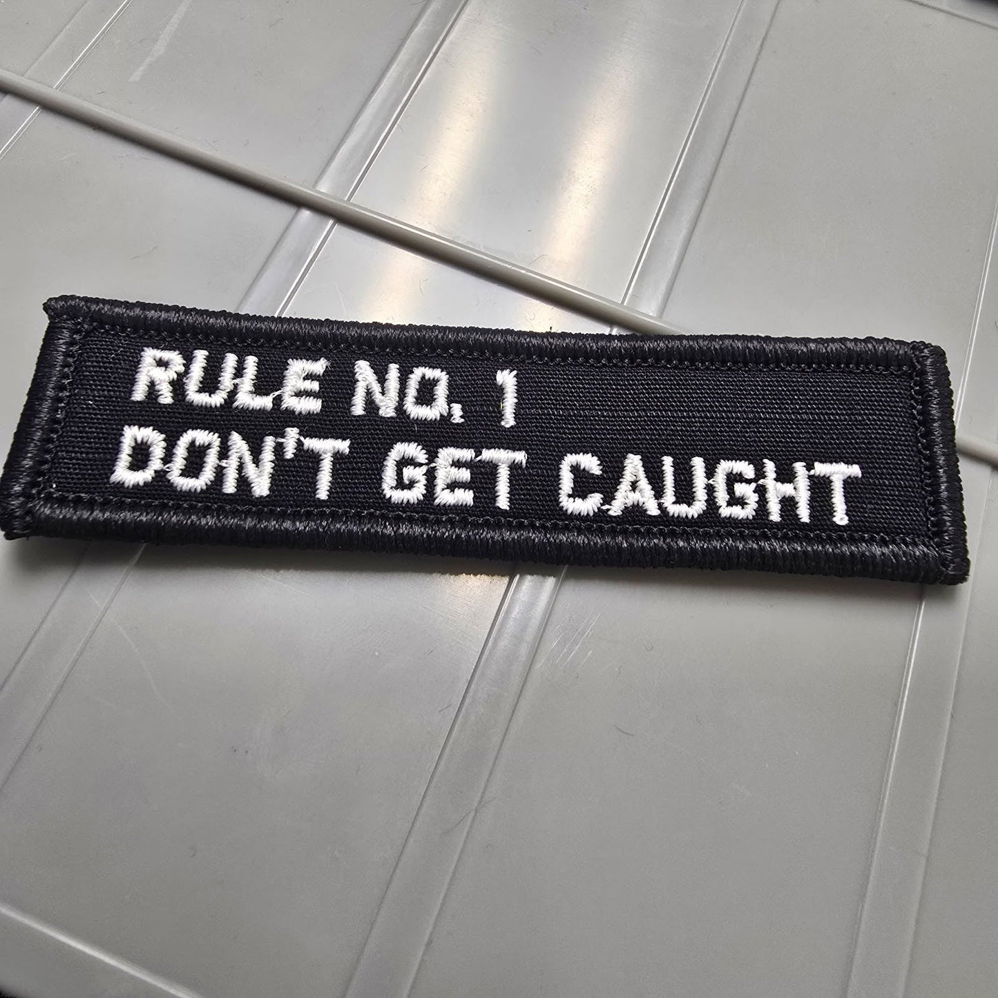 As Seen on Socials - Rule No. 1 - Don't Get Caught - 1x3.75 Patch - Black w/White