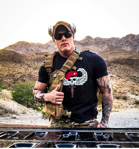 Man with bag wearing the Gray OG WETSU Airborne Logo shirt