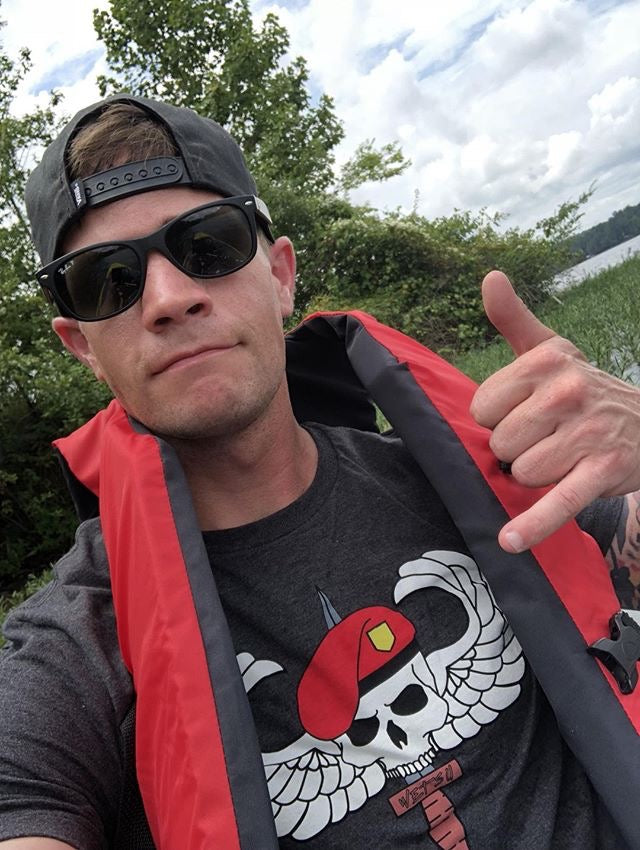 Man in shades wearing the Gray OG WETSU Airborne Logo shirt