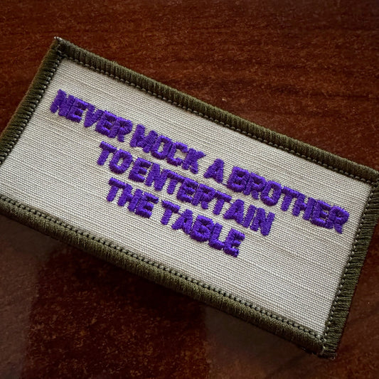 As Seen on Socials - Never Mock A Brother To Entertain The Table - 2x4 Patch - Desert Tan w/Purple