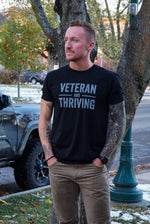 Load image into Gallery viewer, Veteran + Thriving T-Shirt
